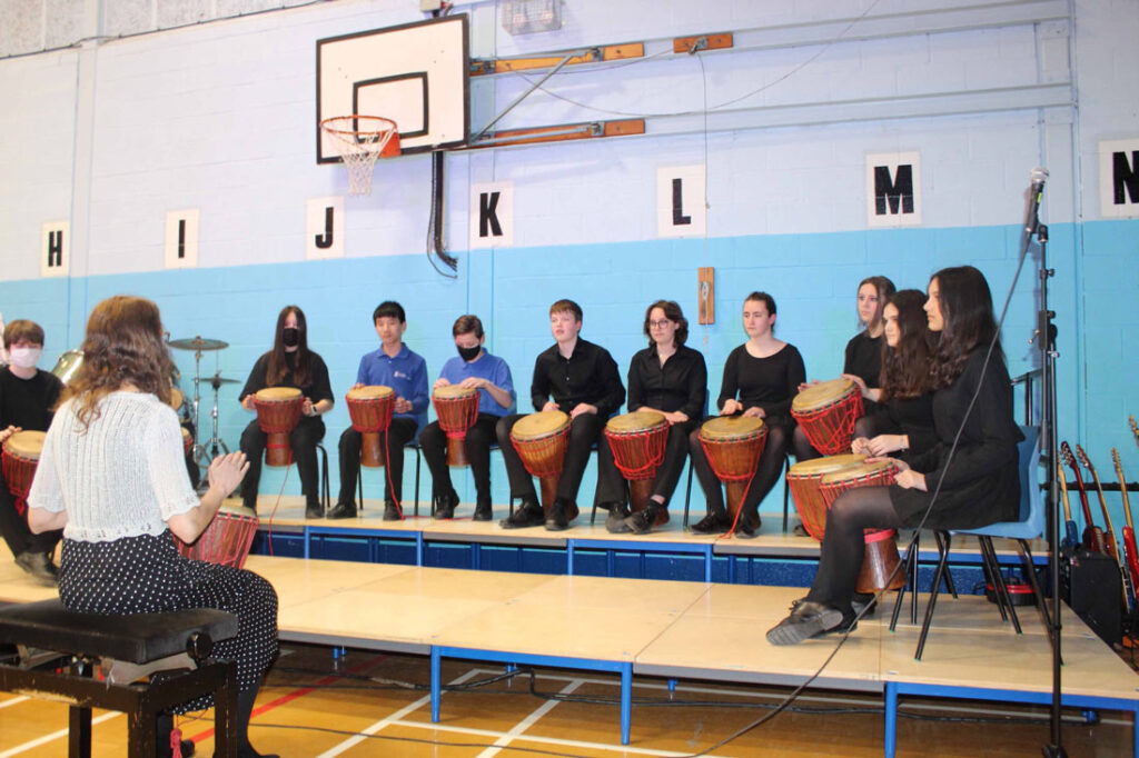 Students playing bongo drums during spring concert