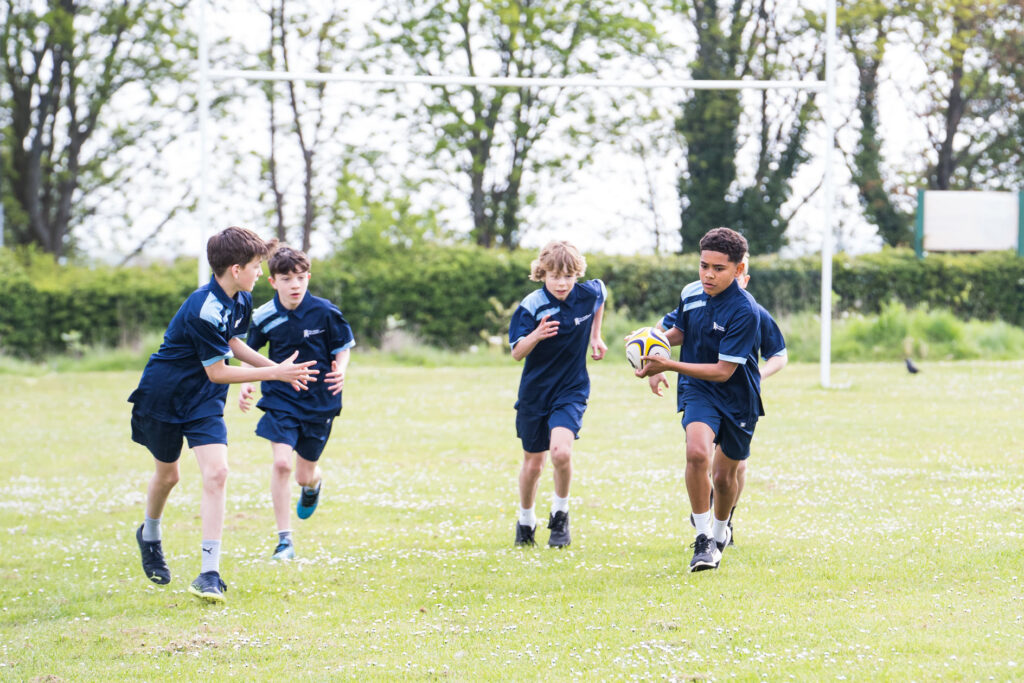 Students playing rugby PE.